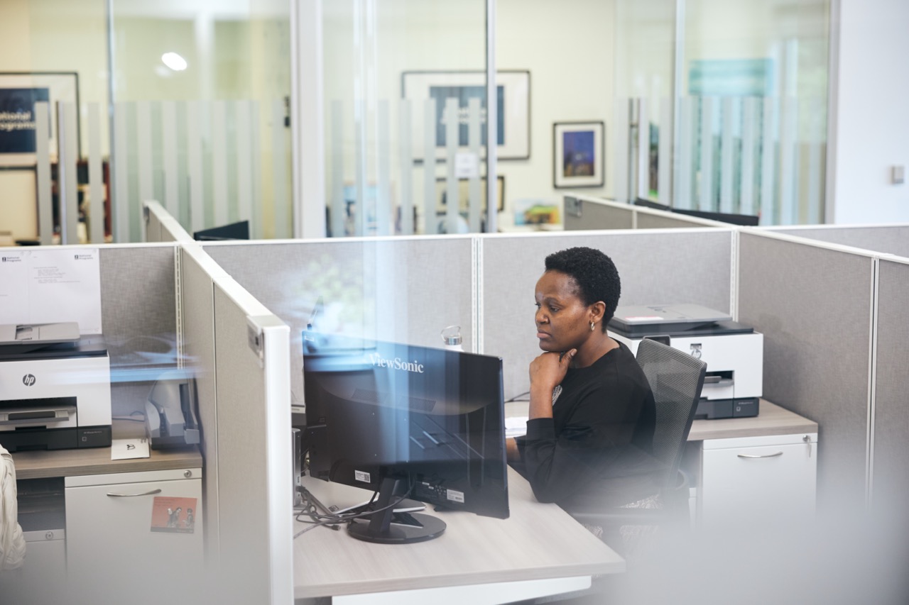 Employee sitting in a cubicle